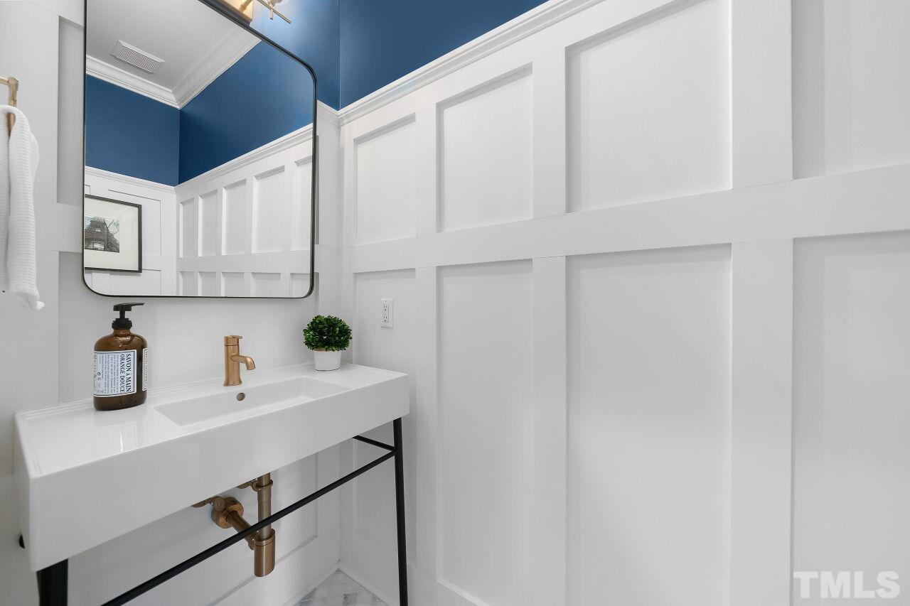 5533 Overleaf Court Raleigh, NC 27615 - Photo 6 of 32 a kitchen with white cabinets and white appliances