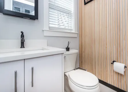a white toilet sitting next to a bathroom sink