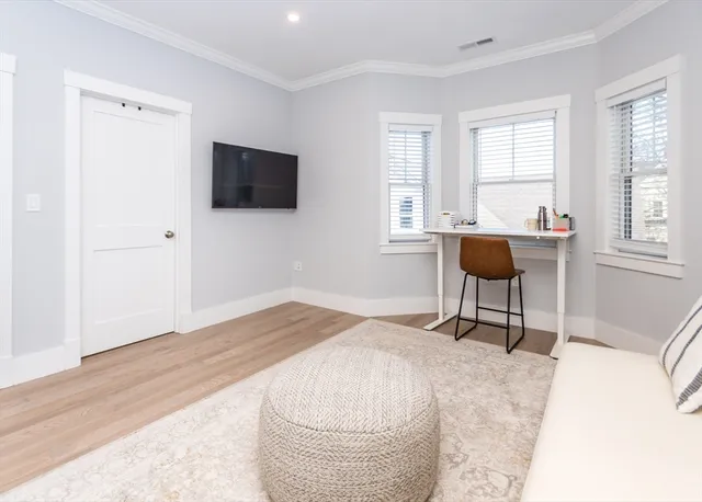 a room with a bed and a chair in it