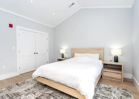 a bedroom with a bed and a lamp