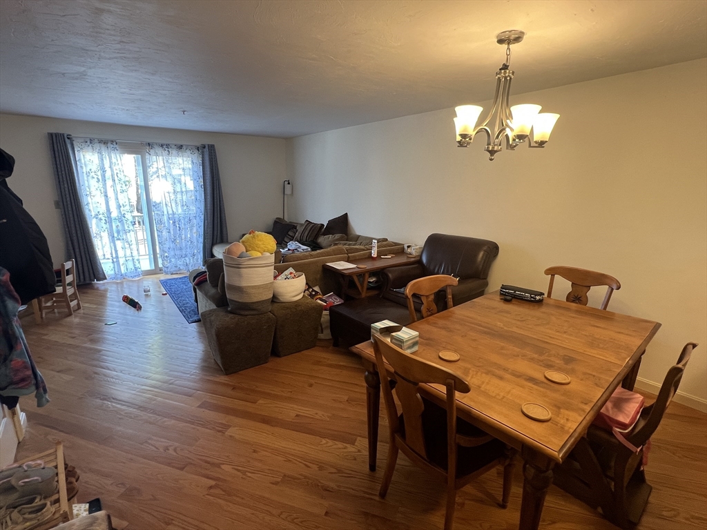 33 Lenglen Road, Unit 33 Newton, MA 02458 - Photo 4 of 9 a view of a dining room with furniture a chandelier and wooden floor