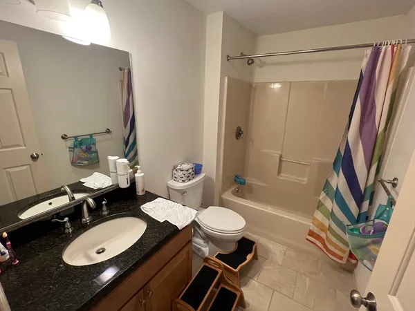 a bathroom with a sink a toilet and tub