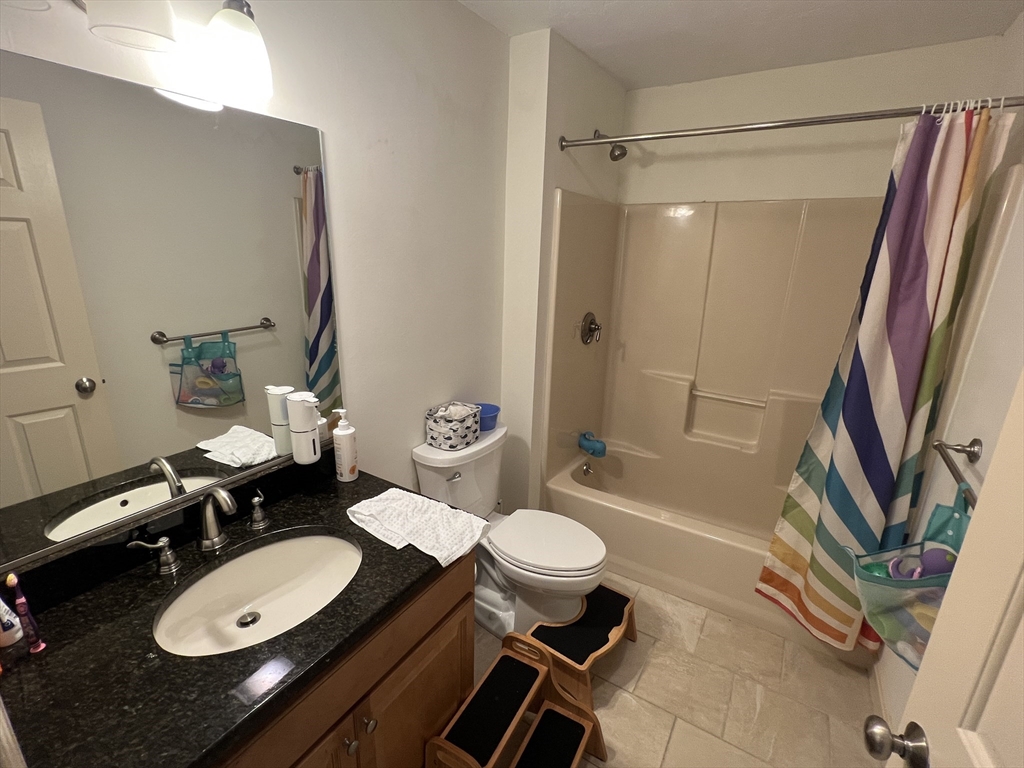 33 Lenglen Road, Unit 33 Newton, MA 02458 - Photo 7 of 9 a bathroom with a sink a toilet and tub