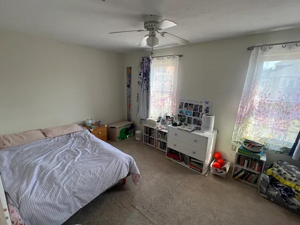 a bed room with a bed and a window