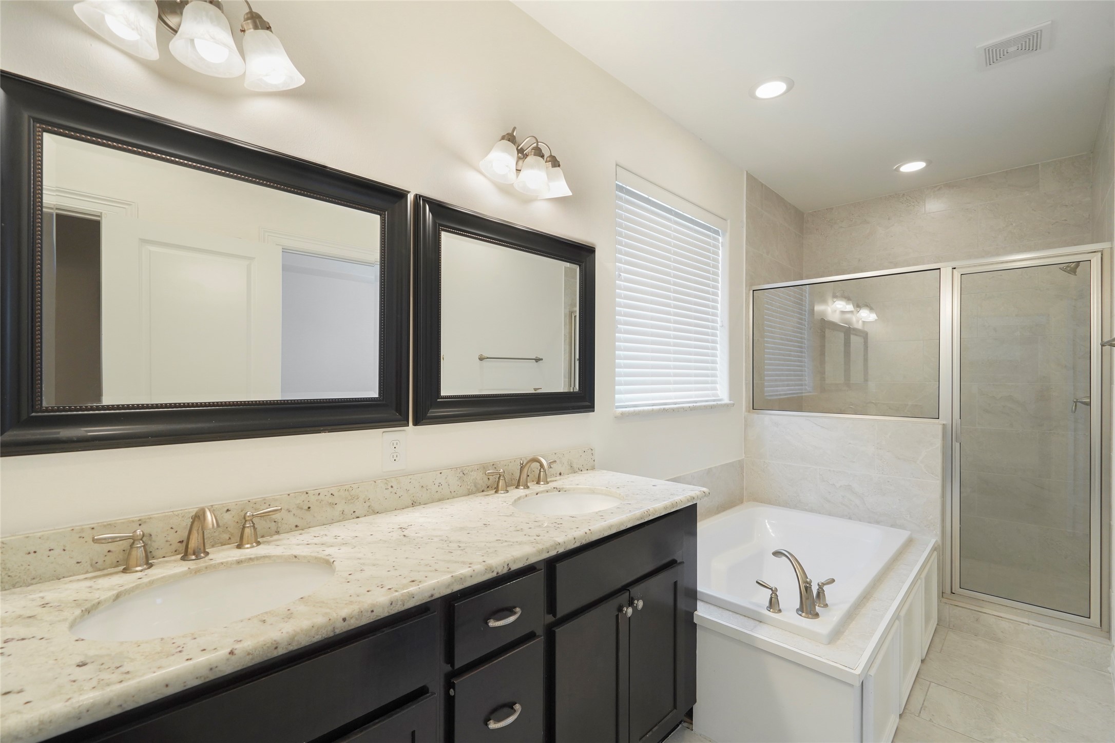 724 Link Road Houston, TX 77009 - Photo 12 of 20 The primary bathroom has it all!
Dual vanities with plenty of
storage, and spa-like features.