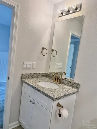 a bathroom with a sink a mirror and a shower