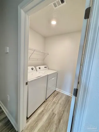 a kitchen with granite countertop white cabinets and stainless steel appliances
