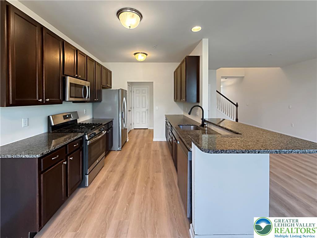 5335 Jutland Road Allentown, PA 18104 - Photo 2 of 13 a kitchen with stainless steel appliances granite countertop a sink stove and refrigerator