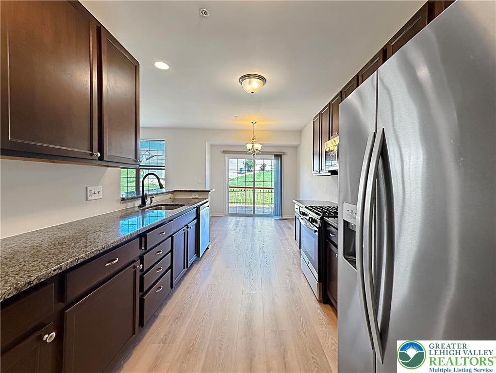 5335 Jutland Road Allentown, PA 18104 - Photo 3 of 13 a kitchen with stainless steel appliances granite countertop a refrigerator a sink a stove and a wooden floors
