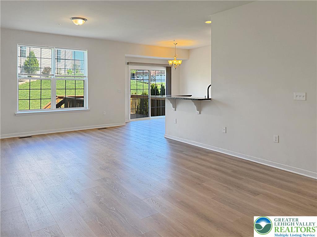5335 Jutland Road Allentown, PA 18104 - Photo 4 of 13 an empty room with wooden floor and windows