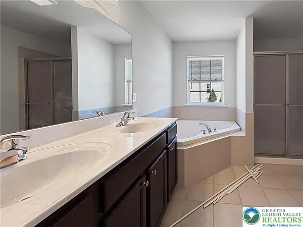 a bathroom with a tub sink and mirror