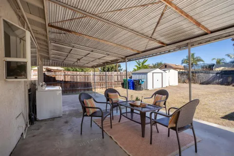 a view of a chairs and table in the patio