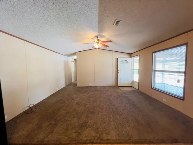 a view of a big room with closet and windows