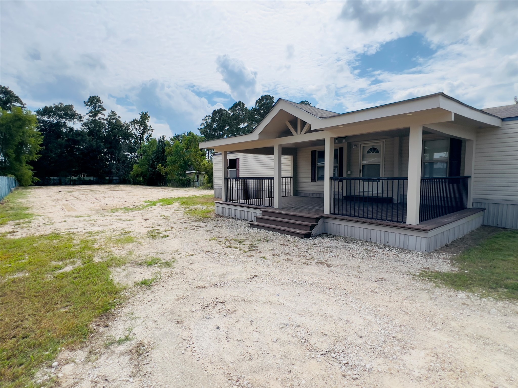 788 County Road 3479 J Cleveland, TX 77327 - Photo 19 of 22 a front view of a house with a yard and garage