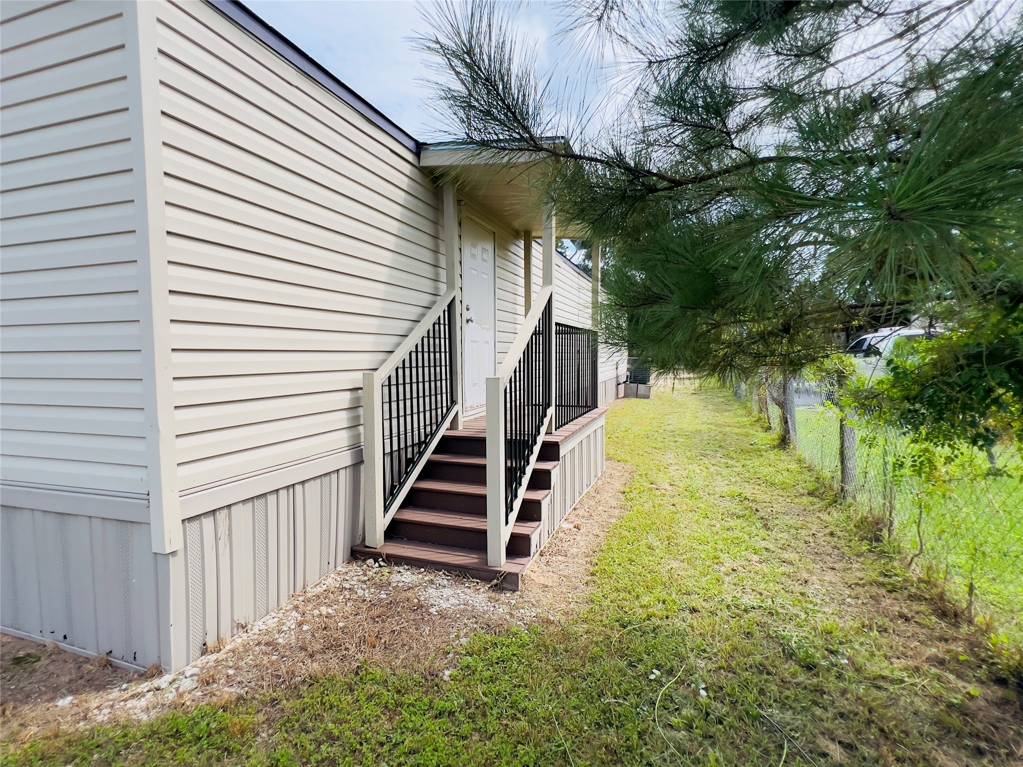 788 County Road 3479 J Cleveland, TX 77327 - Photo 20 of 22 a view of a yard with plants and wooden fence
