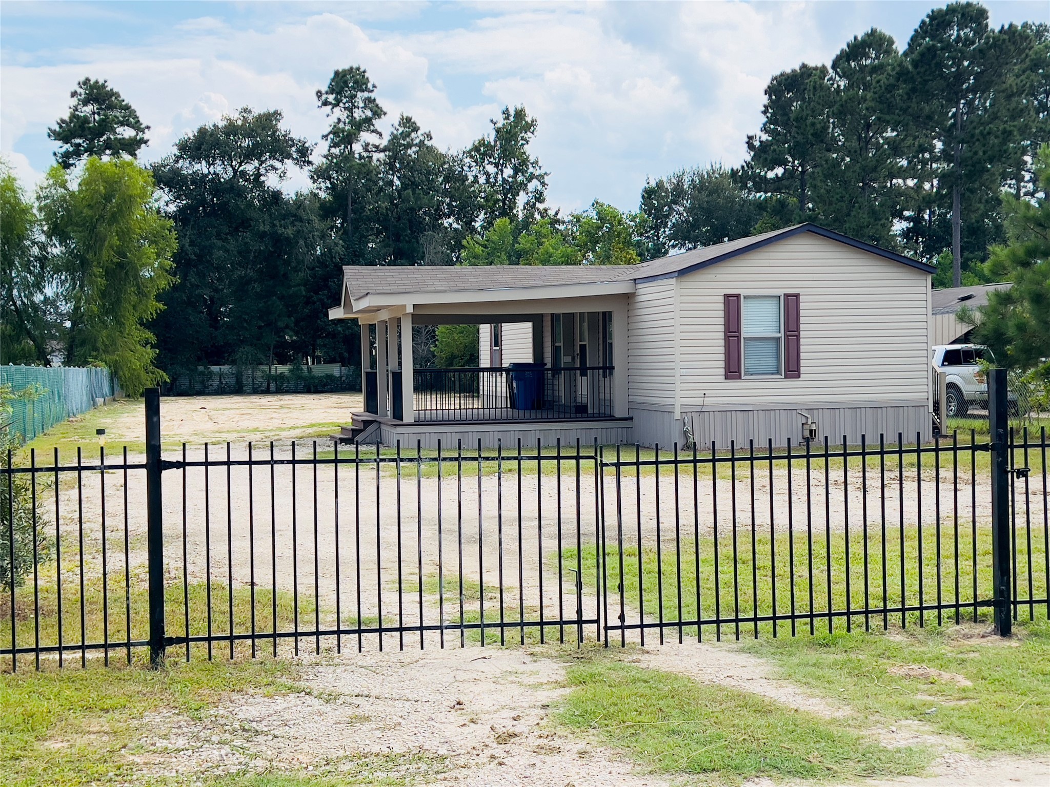 788 County Road 3479 J Cleveland, TX 77327 - Photo 21 of 22 a front view of a house with a garden and plants
