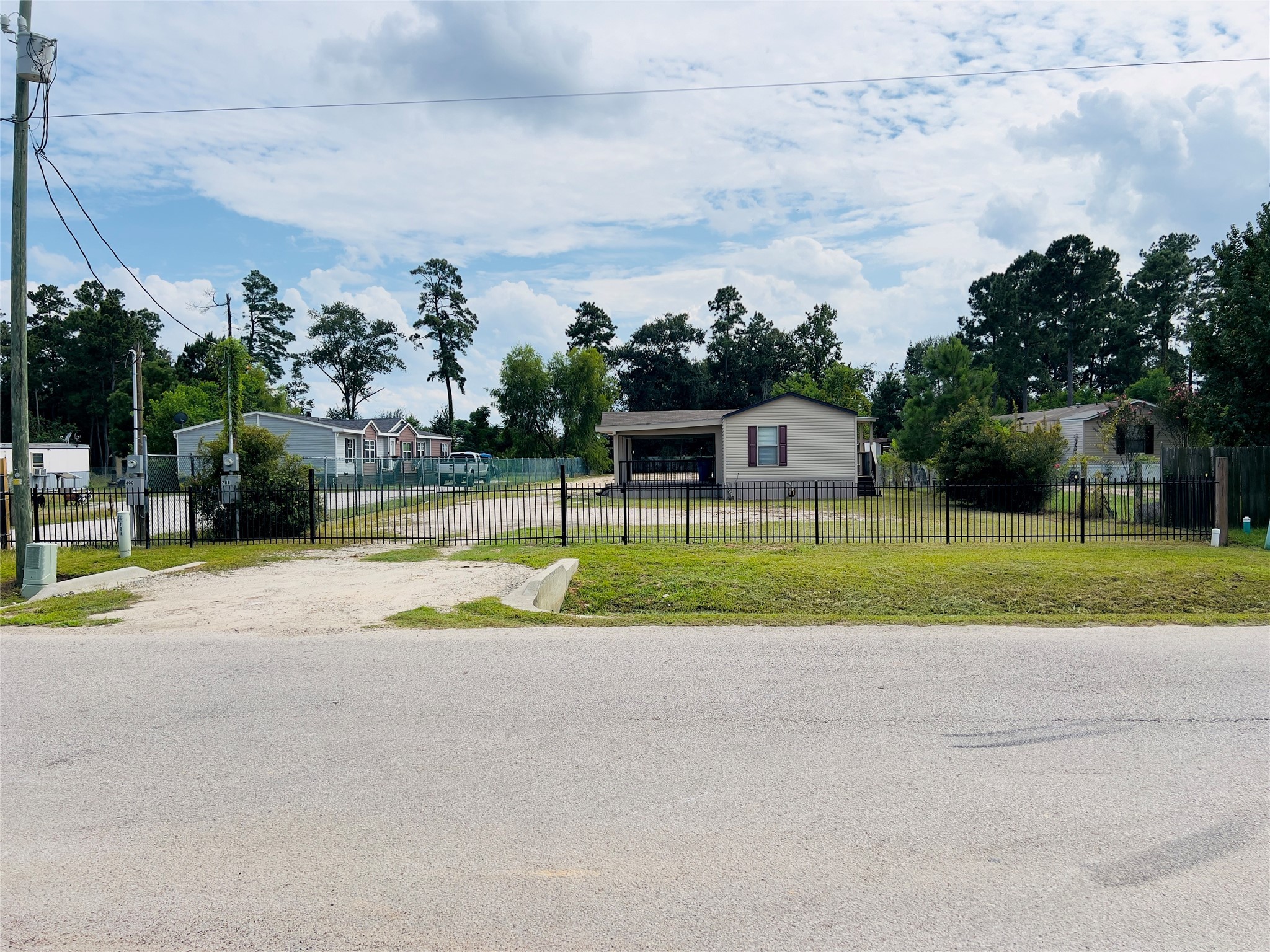 788 County Road 3479 J Cleveland, TX 77327 - Photo 22 of 22 a view of a house with a big yard and potted plants