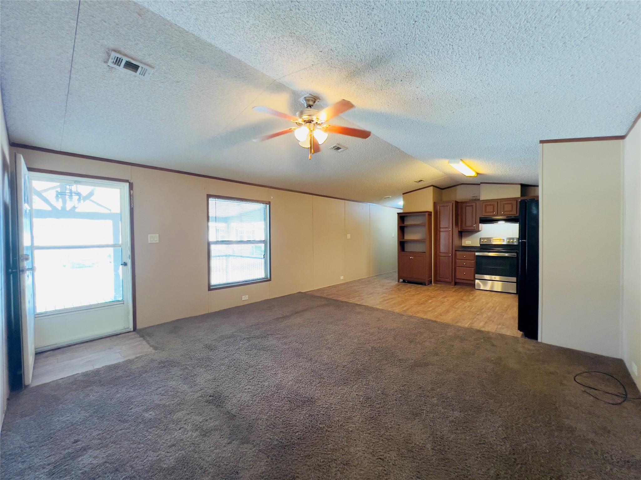 788 County Road 3479 J Cleveland, TX 77327 - Photo 7 of 22 a view of an empty room with a window