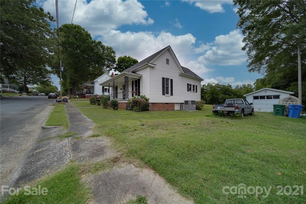 621 Graham Street Albemarle, NC 28001 - Photo 2 of 24 a front view of a house with a garden and trees