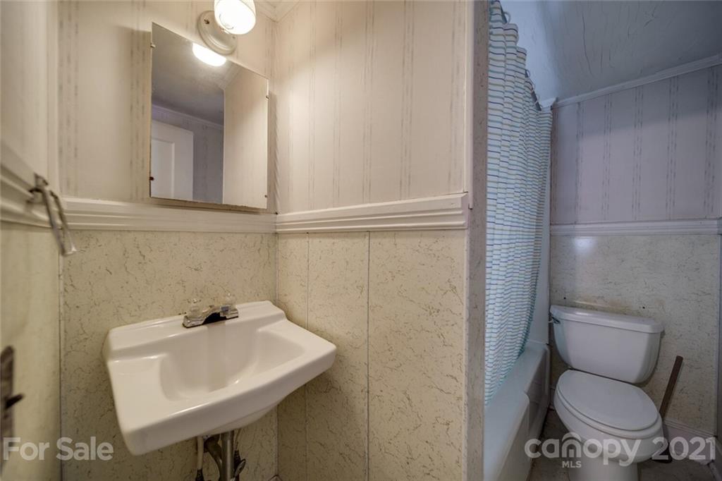 621 Graham Street Albemarle, NC 28001 - Photo 11 of 24 a bathroom with a toilet sink and mirror