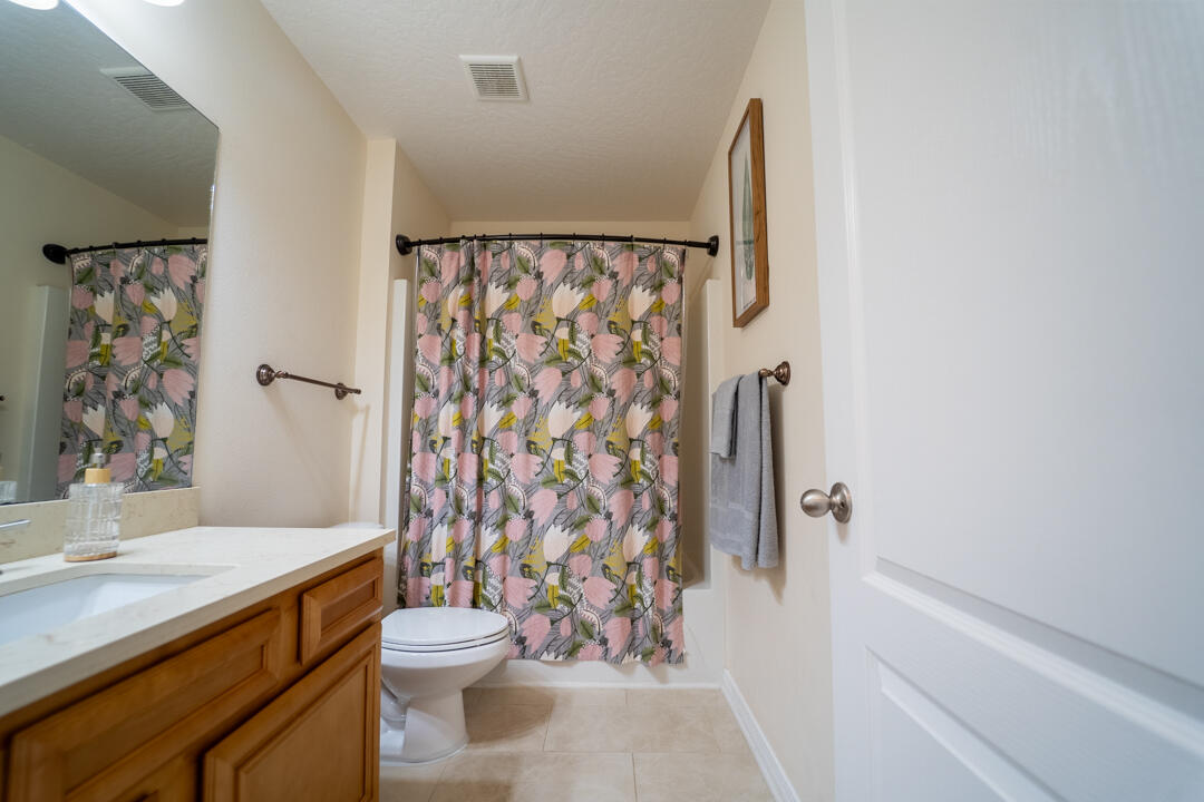 103 6th Avenue Shalimar, FL 32579 - Photo 15 of 23 a bathroom with a granite countertop toilet a sink and a shower