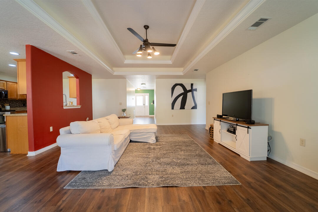 103 6th Avenue Shalimar, FL 32579 - Photo 3 of 23 a living room with hard wood floors and a flat screen tv