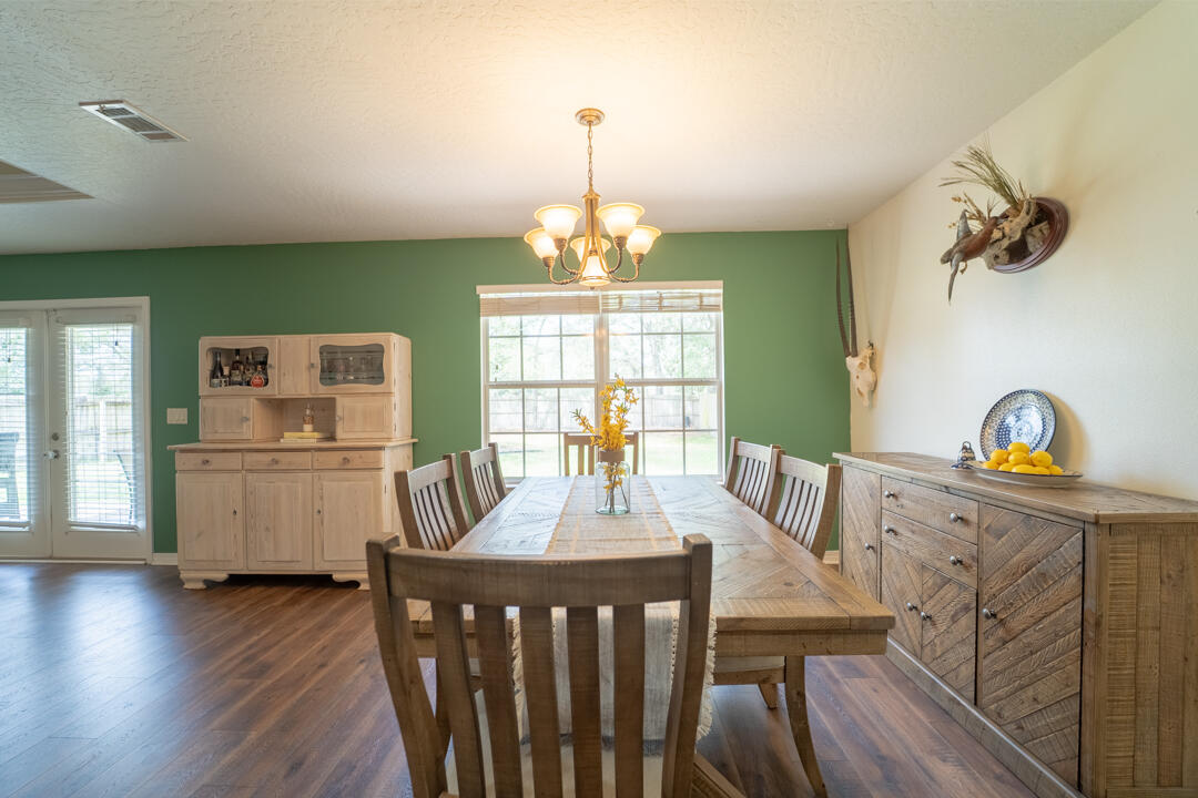 103 6th Avenue Shalimar, FL 32579 - Photo 6 of 23 a view of a dining room with furniture window and wooden floor
