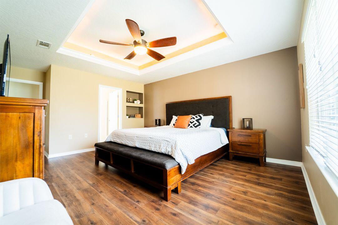 103 6th Avenue Shalimar, FL 32579 - Photo 9 of 23 a bedroom with a bed and wooden floor