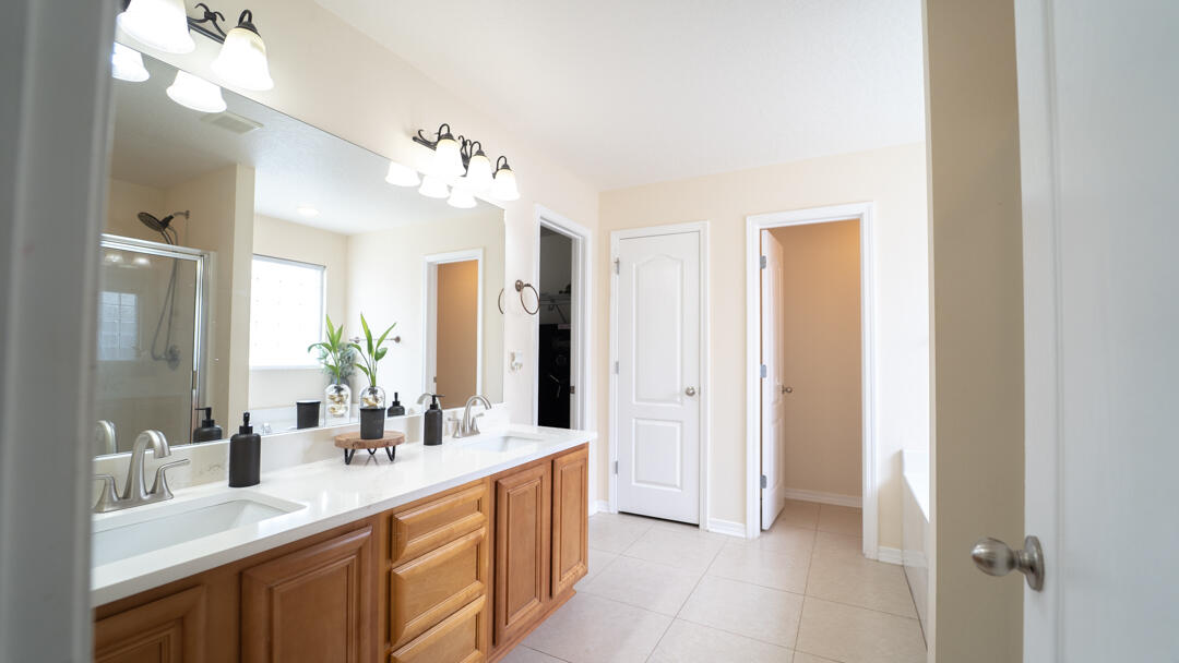 103 6th Avenue Shalimar, FL 32579 - Photo 10 of 23 a bathroom with a double vanity sink and a mirror
