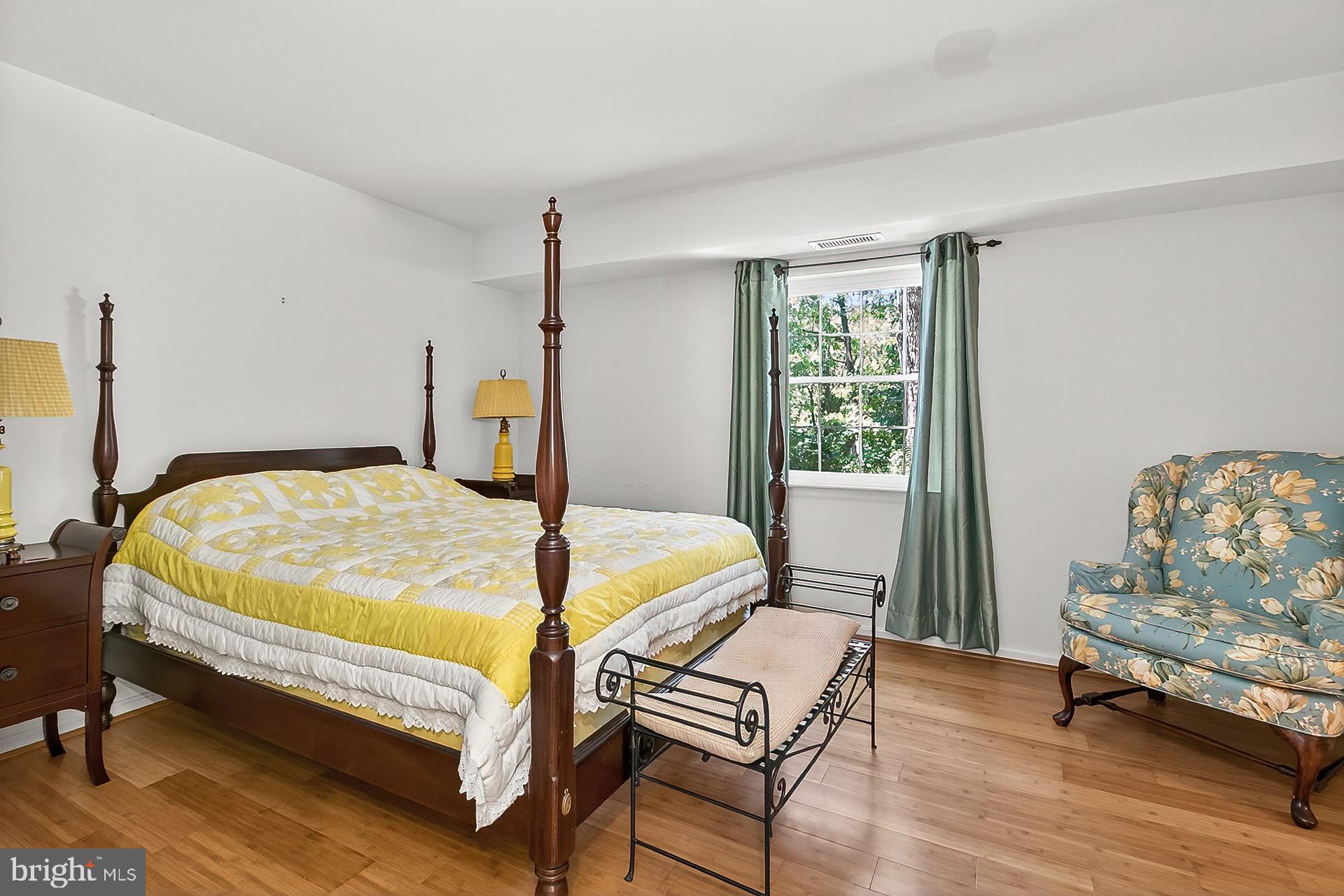 5920 Cove Landing Road, Unit 102 Burke, VA 22015 - Photo 12 of 45 a bedroom with a bed a couch and dresser