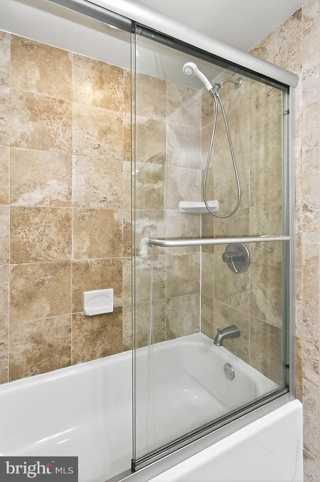 5920 Cove Landing Road, Unit 102 Burke, VA 22015 - Photo 13 of 45 a bathroom with a bathtub and a shower