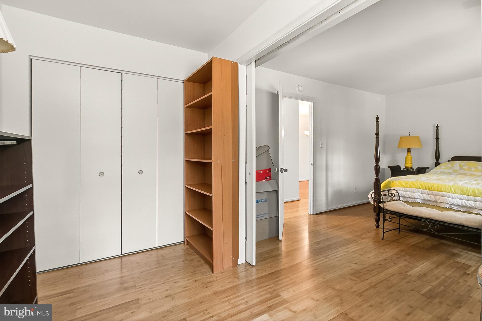 5920 Cove Landing Road, Unit 102 Burke, VA 22015 - Photo 18 of 45 a bedroom with a bed and wooden floor