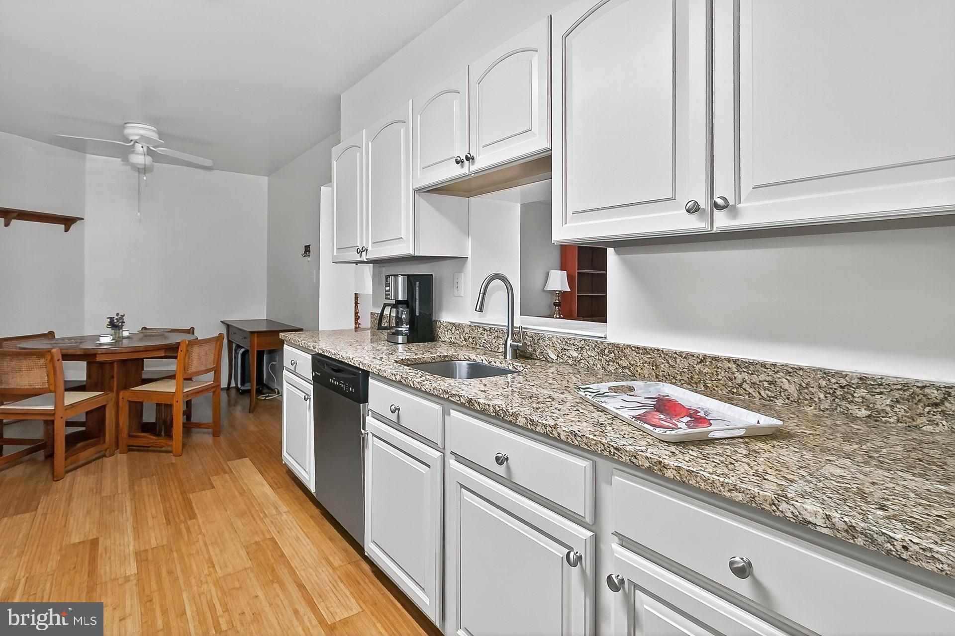5920 Cove Landing Road, Unit 102 Burke, VA 22015 - Photo 2 of 45 a kitchen with granite countertop lots of counter top space and cabinets