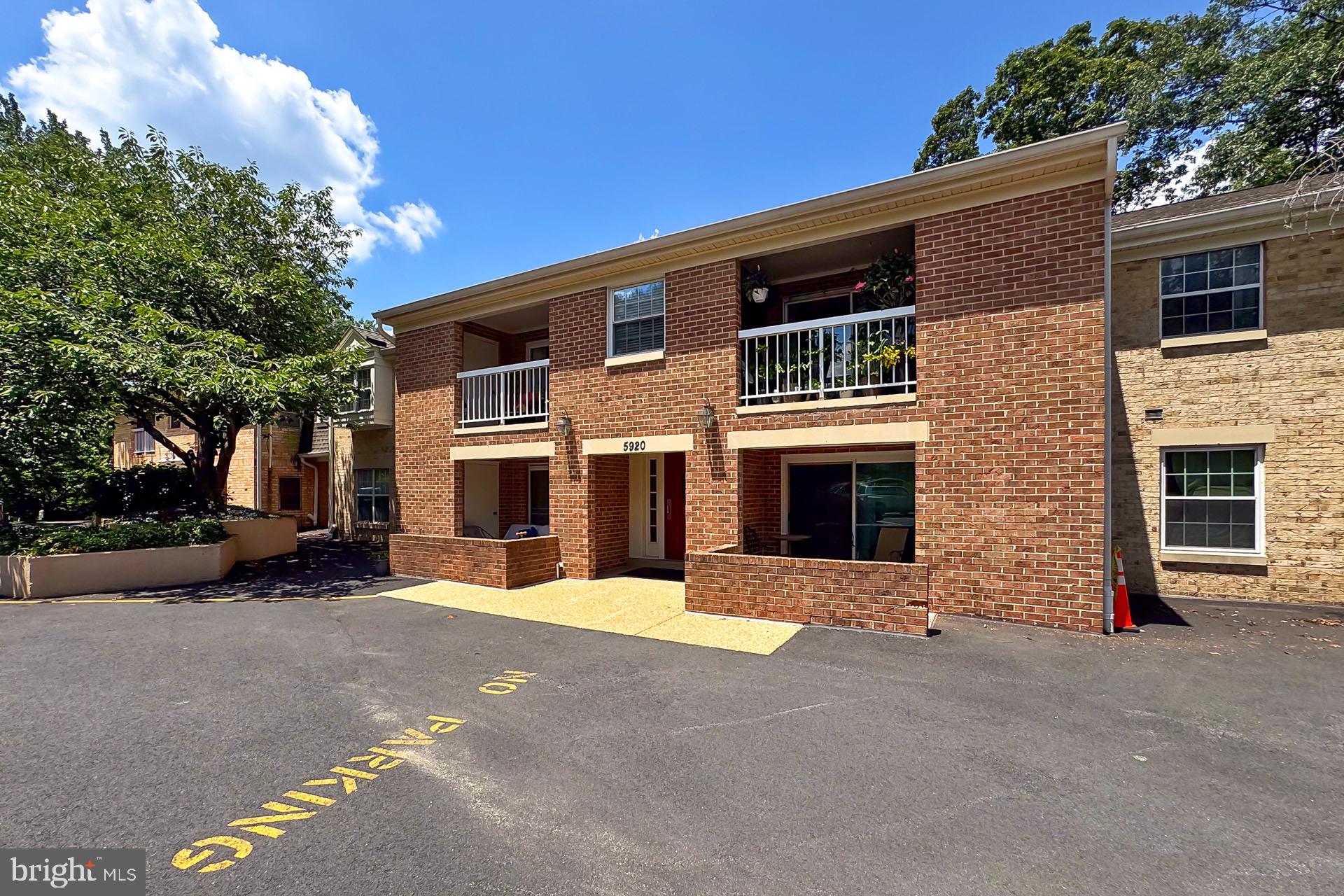 5920 Cove Landing Road, Unit 102 Burke, VA 22015 - Photo 21 of 45 a front view of a house with a yard and garage