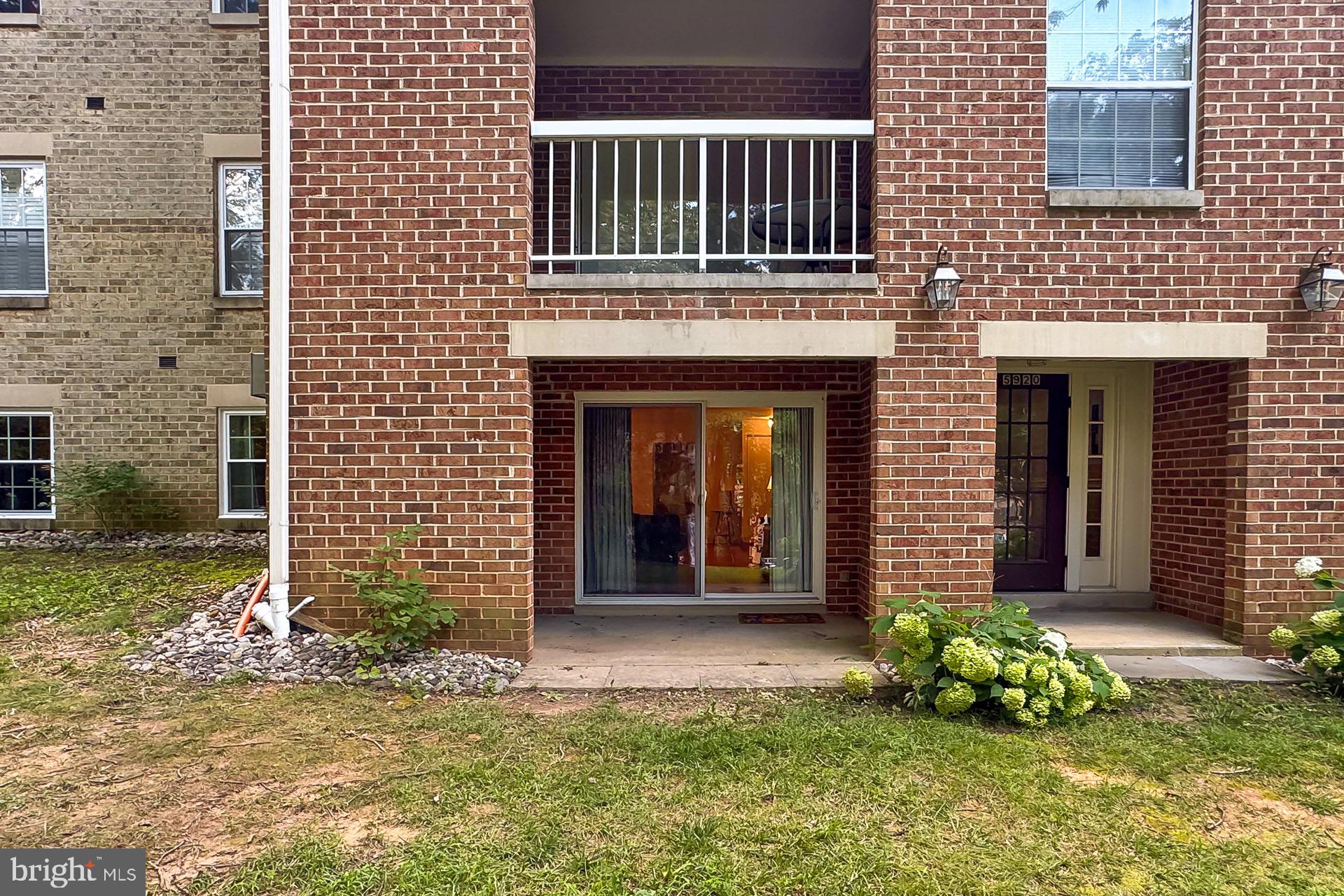 5920 Cove Landing Road, Unit 102 Burke, VA 22015 - Photo 24 of 45 a front view of a house with a yard