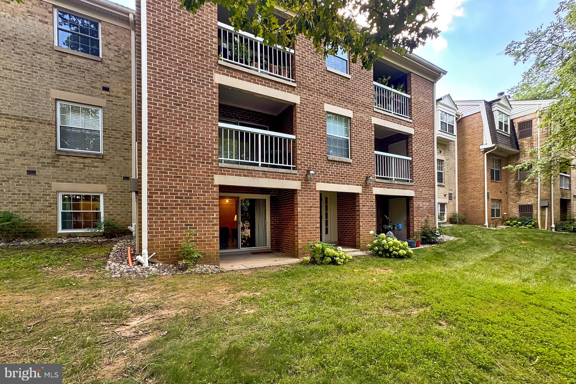 5920 Cove Landing Road, Unit 102 Burke, VA 22015 - Photo 25 of 45 a front view of a house with a yard