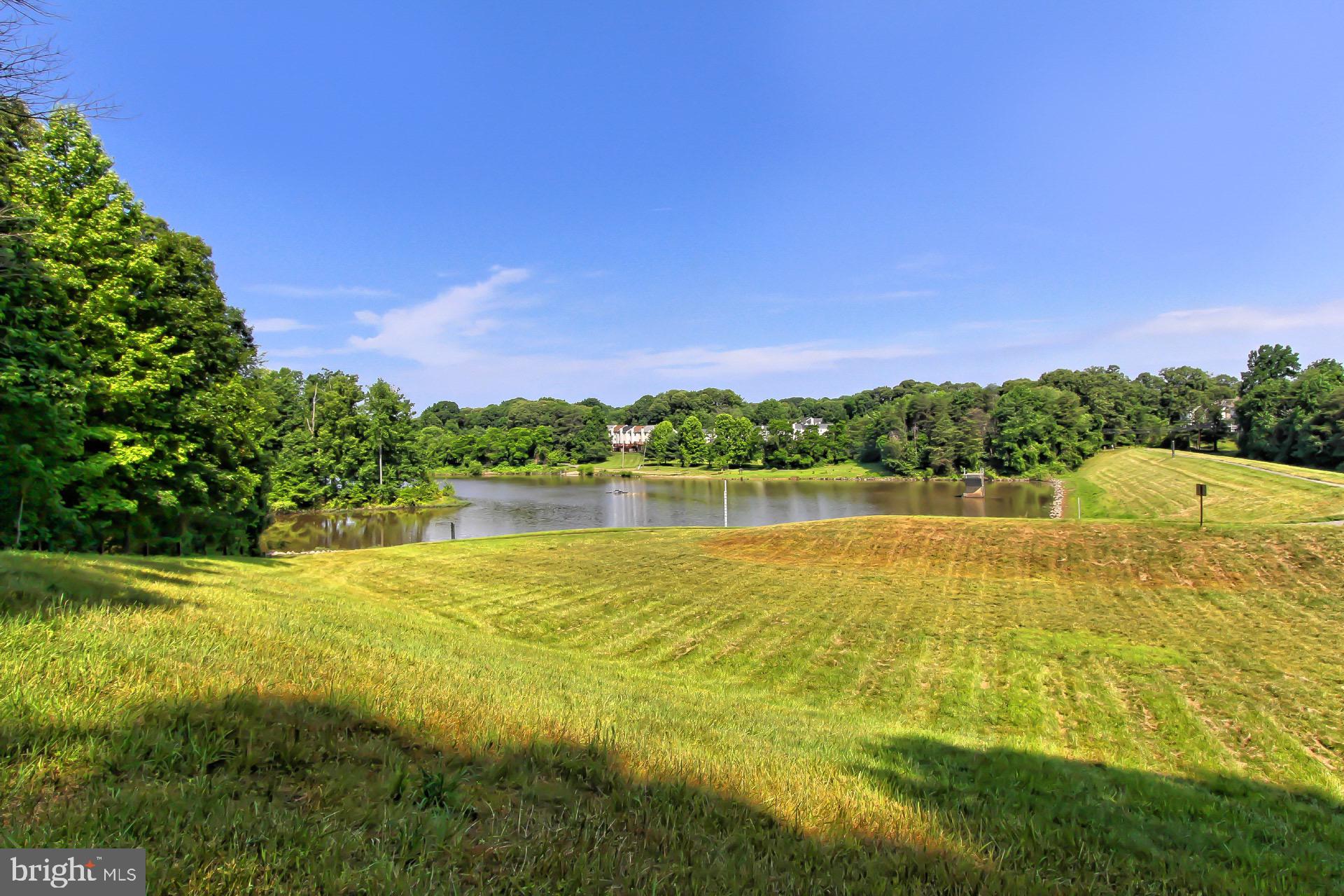 5920 Cove Landing Road, Unit 102 Burke, VA 22015 - Photo 28 of 45 a view of a lake with a house in the background