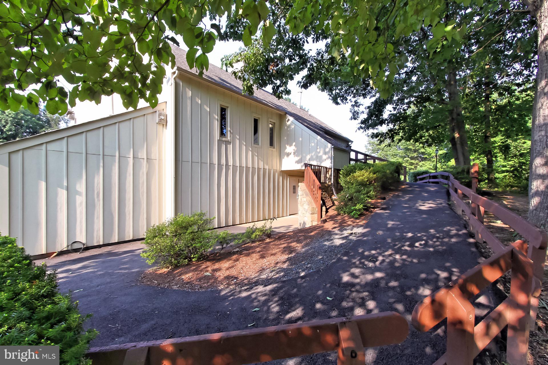 5920 Cove Landing Road, Unit 102 Burke, VA 22015 - Photo 37 of 45 a backyard of a house with plants and tree