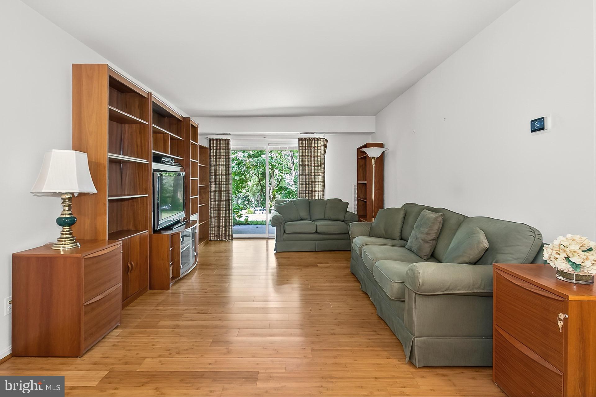 5920 Cove Landing Road, Unit 102 Burke, VA 22015 - Photo 4 of 45 a living room with furniture and a large window