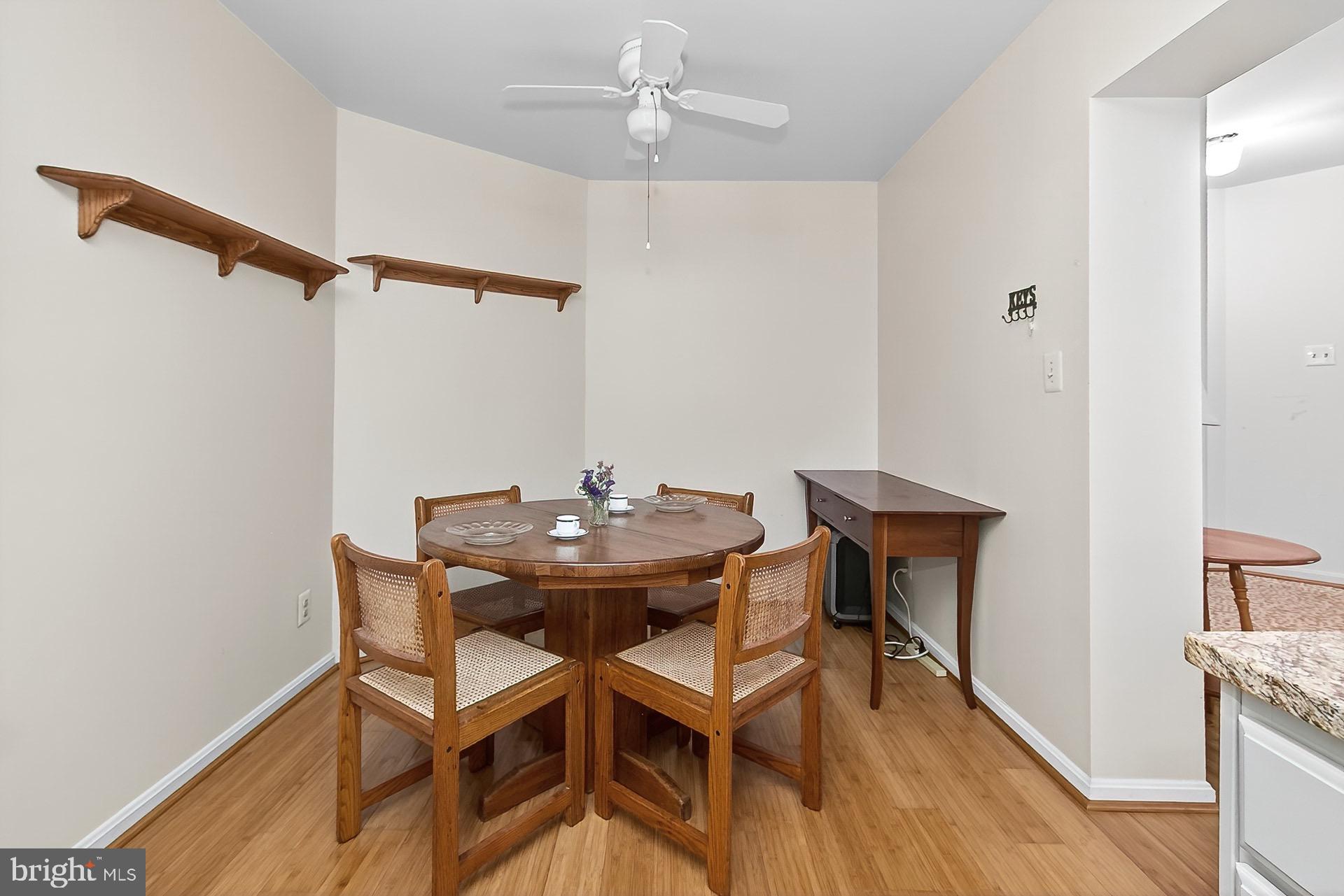 5920 Cove Landing Road, Unit 102 Burke, VA 22015 - Photo 5 of 45 a view of a dining room with furniture and wooden floor