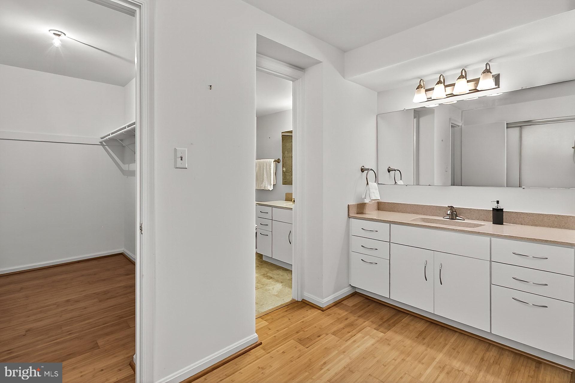5920 Cove Landing Road, Unit 102 Burke, VA 22015 - Photo 8 of 45 a spacious bathroom with a double vanity sink a mirror and a shower