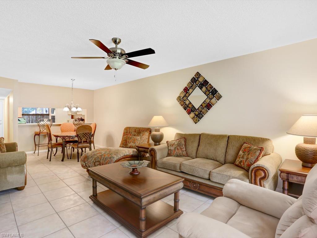 5675 Whitaker Road, Unit B102 Naples, FL 34112 - Photo 5 of 22 a living room with furniture