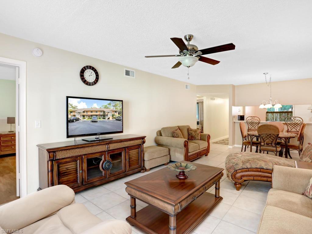 5675 Whitaker Road, Unit B102 Naples, FL 34112 - Photo 6 of 22 a living room with furniture and a flat screen tv