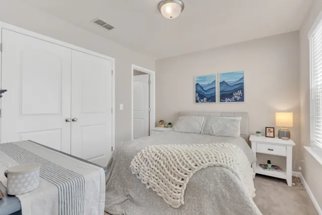 a bedroom with a bed and a lamp