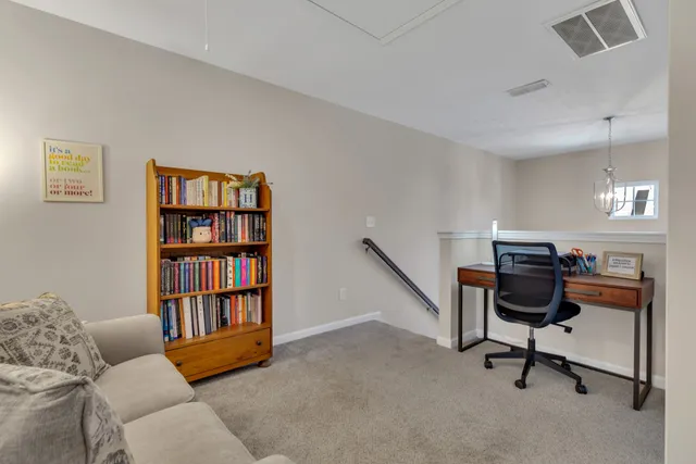 a view of a livingroom with workspace and a couch