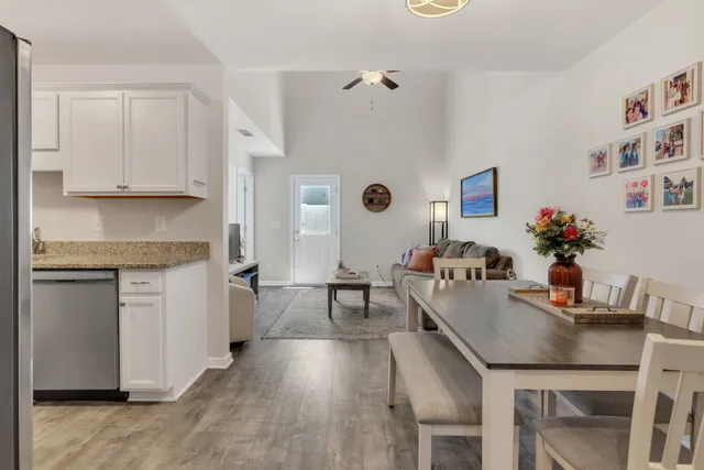 a dining room with furniture and wooden floor
