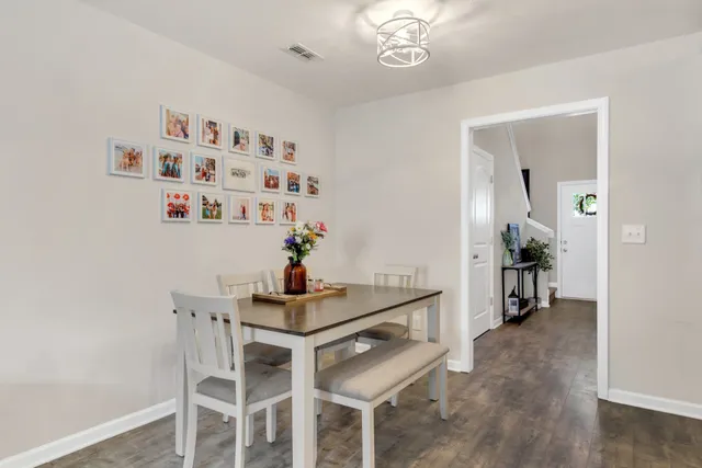 a dining room with furniture and wooden floor