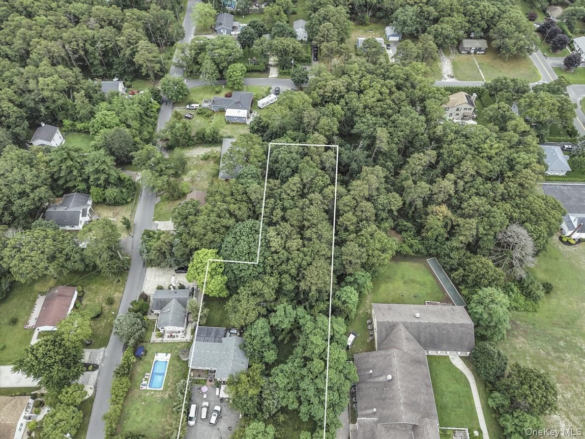 669 Flanders Road Flanders, NY 11901 - Photo 13 of 15 an aerial view of residential house with outdoor space and trees all around