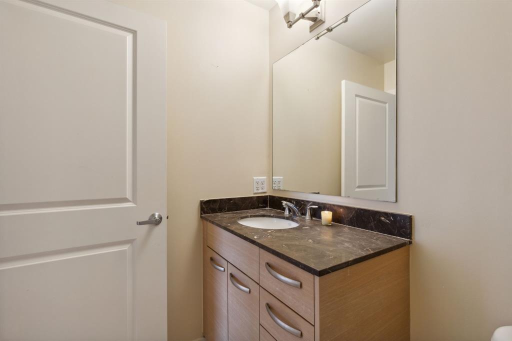 1200 Main Street, Unit 2302 Dallas, TX 75202 - Photo 12 of 22 a bathroom with a granite countertop sink and a mirror