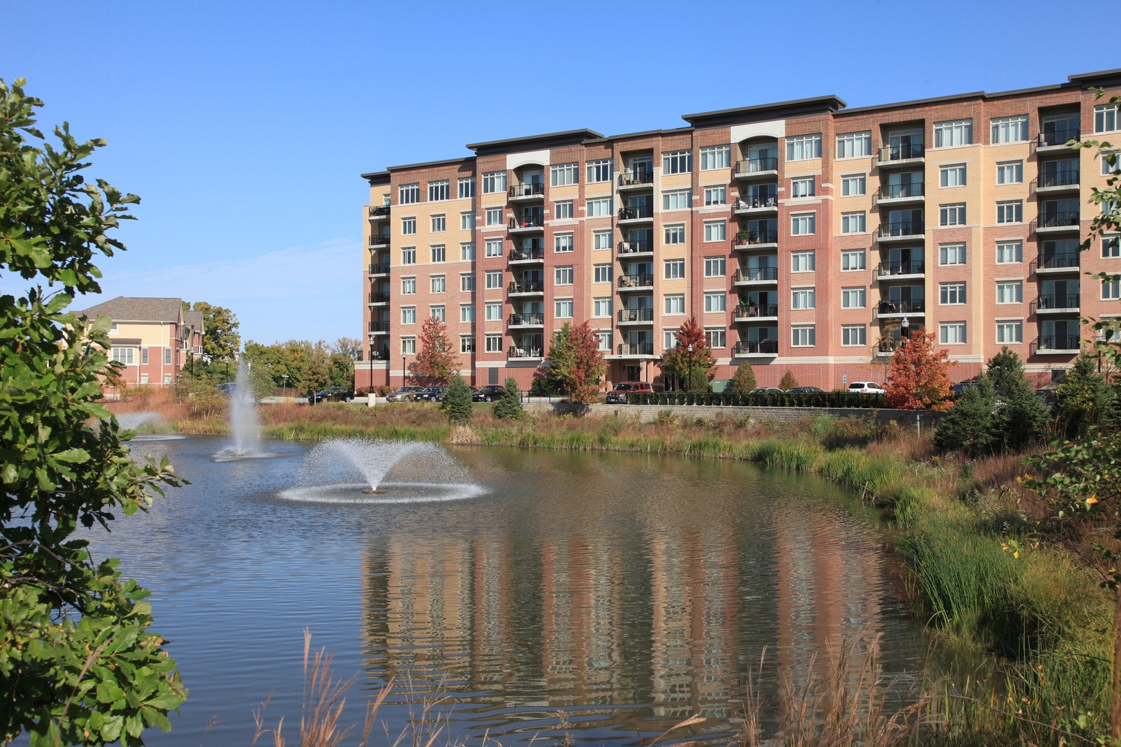 1199 East Port Clinton Road, Unit 610 Vernon Hills, IL 60061 - Photo 1 of 16 a front view of a building with lake view and outdoor space